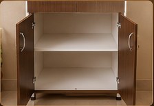 Lower cabinet open with a white interior shelf
